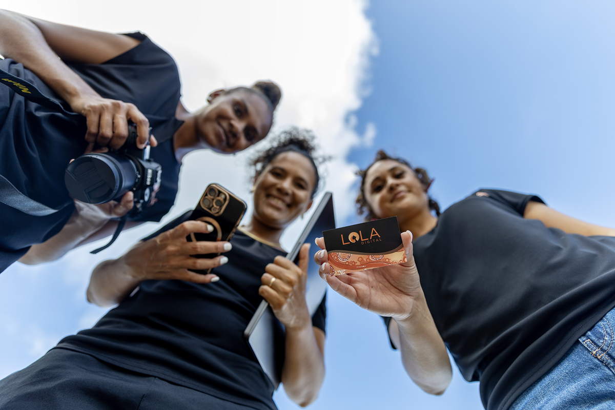 three team members look down at the camera with a cloud above them
