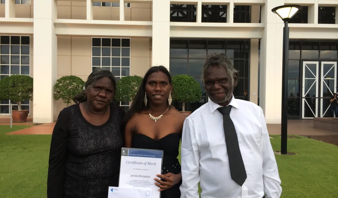 Jericka Mungatopi proudly showing off her award with parents Katrina and Fredrick.