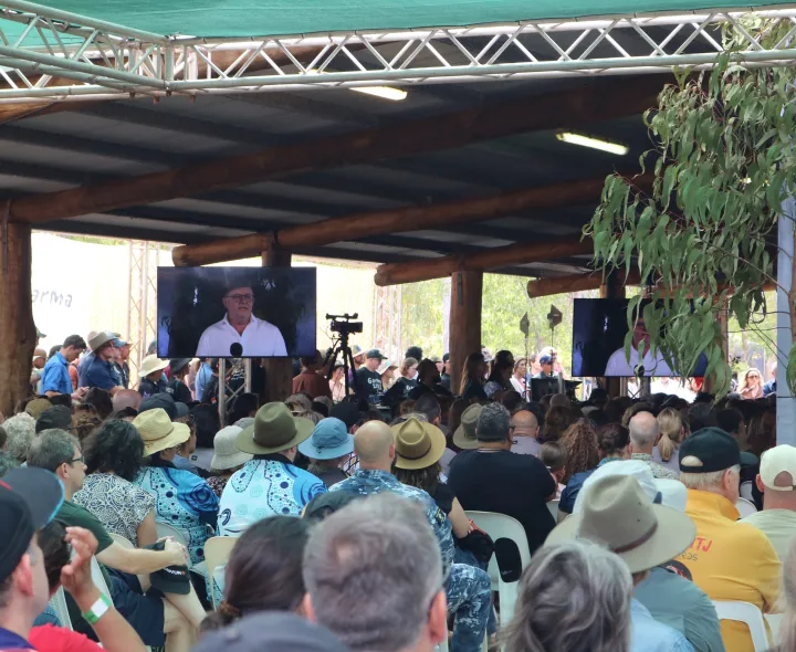 A crowd of people watching the Prime Minister deliver a speech at Garma Festival