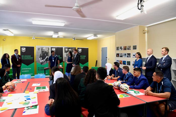 24 people standing in a school classroom including The Duke and Duchess of Sussex and NSW Premier Gladys Berejiklian