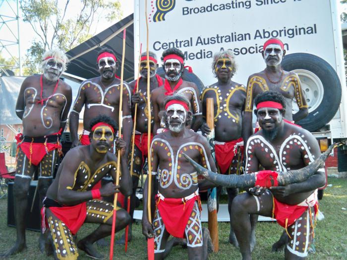 A group of Indigenous men dressed in traditional costume