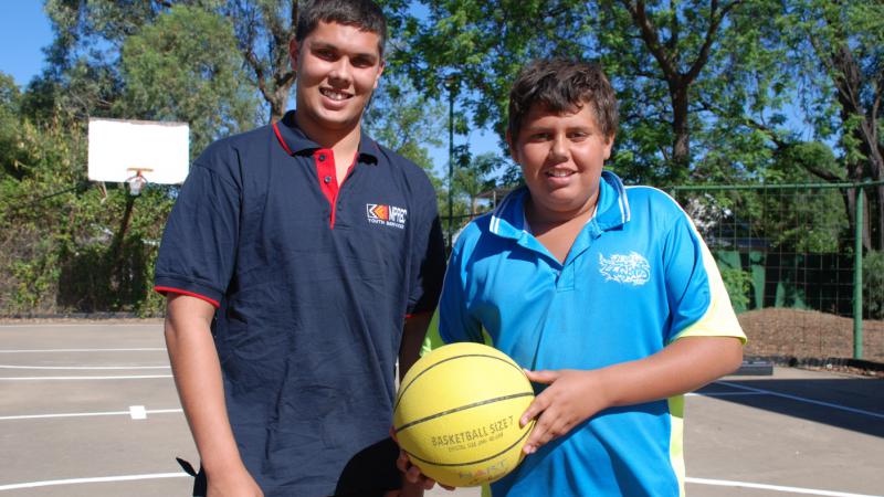 Youth worker, Kayne Fernando and younger brother Riley, on the basketball courts at the Coonamble Youth Centre.